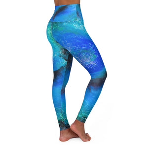 a woman wearing a blue and green psychedelic print yoga pants.	