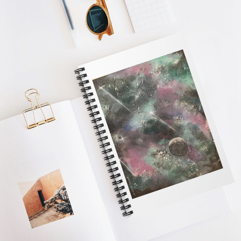 a spiral notebook with a painting of outer space.	