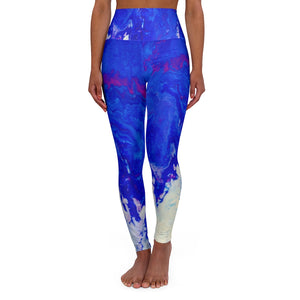 a woman wearing a blue and purple psychedelic print yoga pants leggings.	