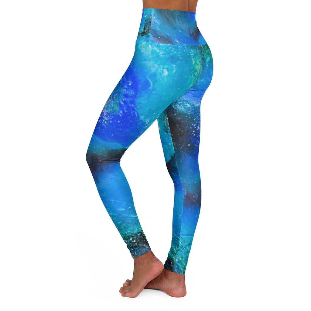 a woman wearing a blue and green psychedelic print leggings.	