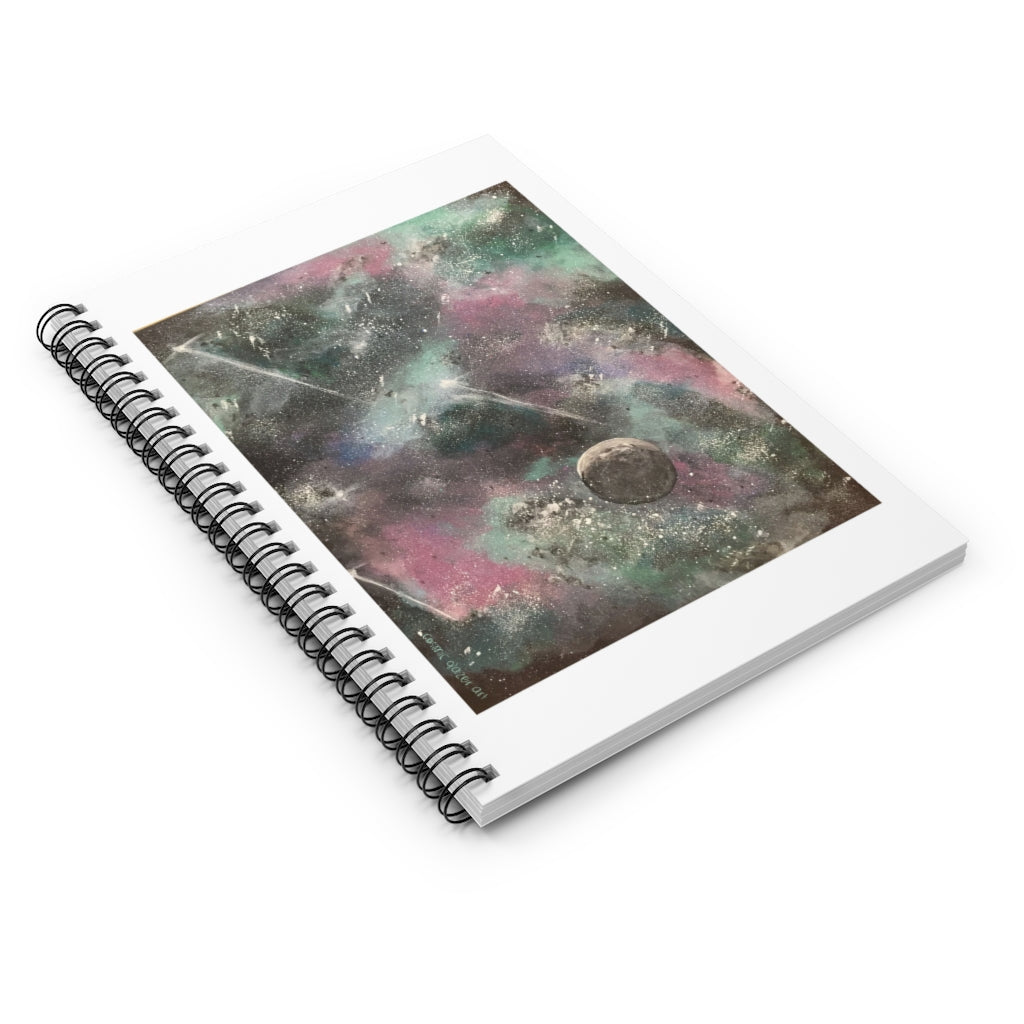 a spiral notebook with a painting of outer space.	