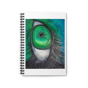 a spiral notebook with a drawing of a green alien eye.	
