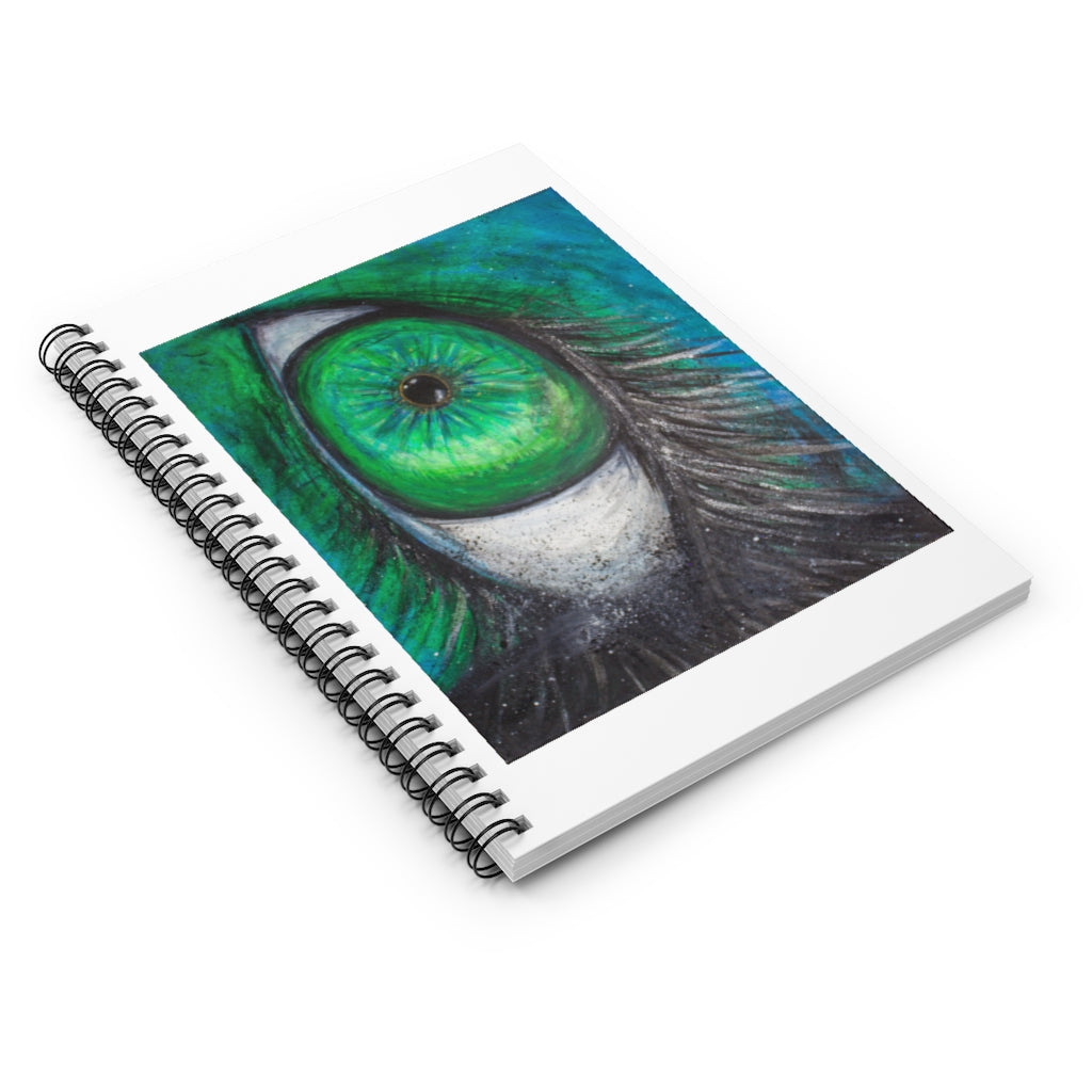 a spiral notebook with a drawing of a green eye.	
