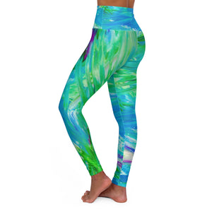 a woman wearing a blue and green yoga pants.	