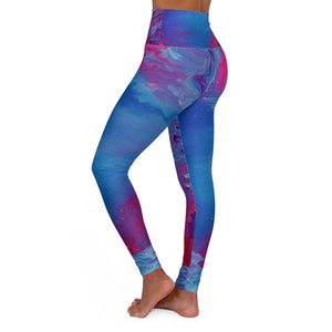 a woman wearing a blue and pink psychedelic print yoga pants.	