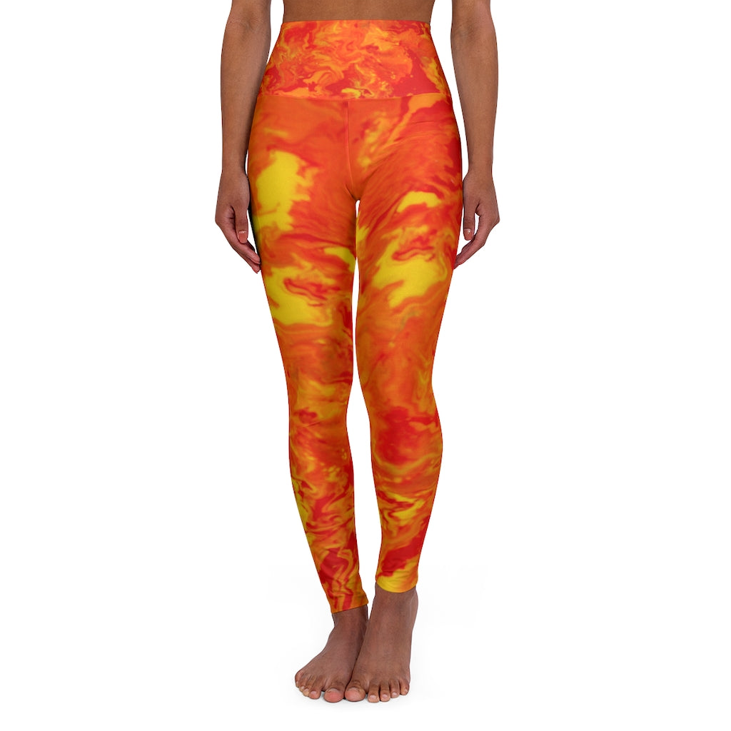 a woman wearing a red and yellow tie dye leggings.