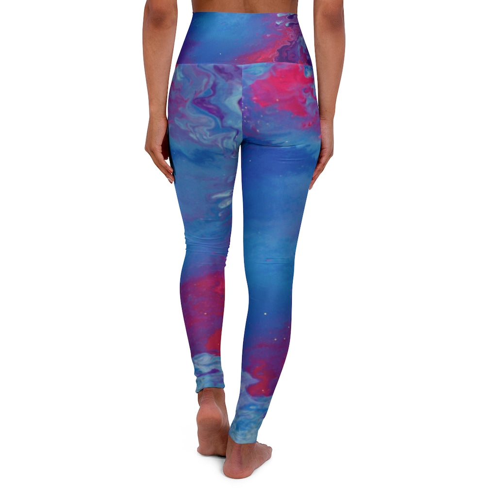 a woman wearing a blue and pink psychedelic leggings.	
