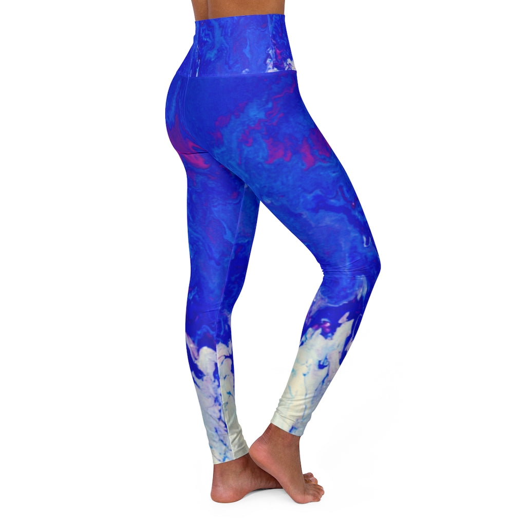 a woman wearing a blue and purple yoga pants.	