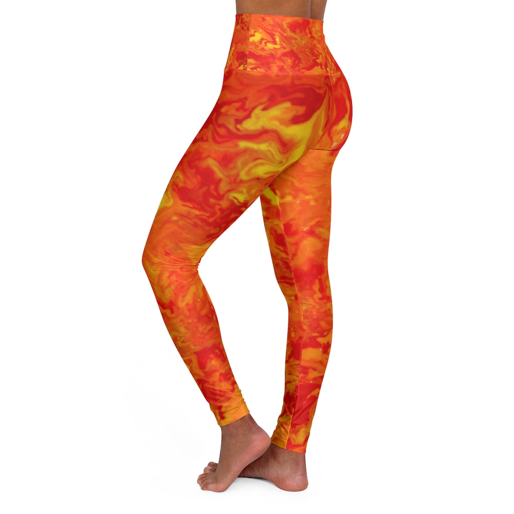 a woman wearing a red and yellow tie dye leggings.