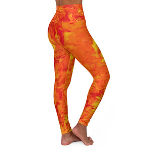 a woman wearing a red and yellow psychedelic tie dye leggings.