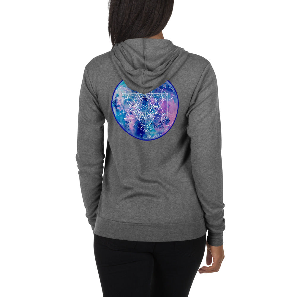 a woman in a grey zip hoodie with a blue and purple geometric design.	