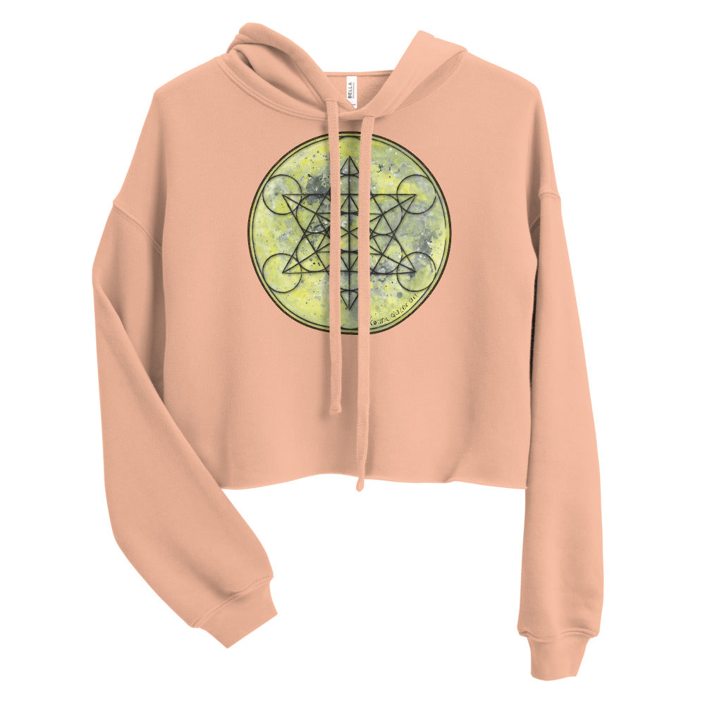 a cropped peach crop top hoodie with a geometric design on the front.